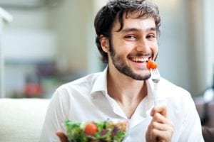 Young man eating a healthy salad-img-blog