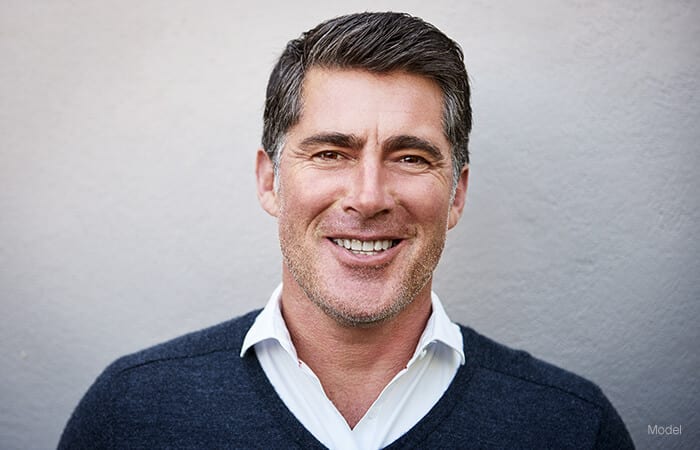 male model smiling for neck lift