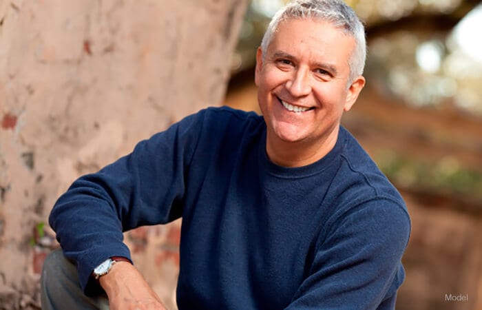 male model wearing a blue long sleeve sweater, grey hair for one stitch facelift