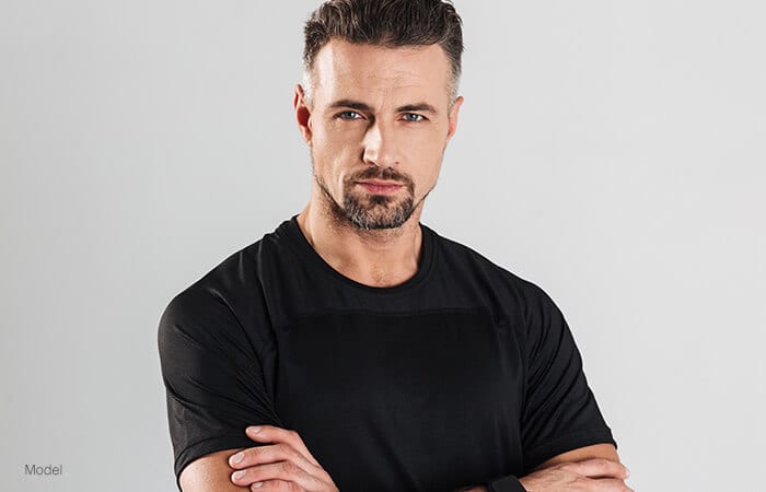 male model wearing a black shirt facing forward for vertical facelift