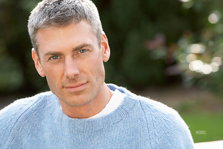 Mid age man looking sharp in blue sweater